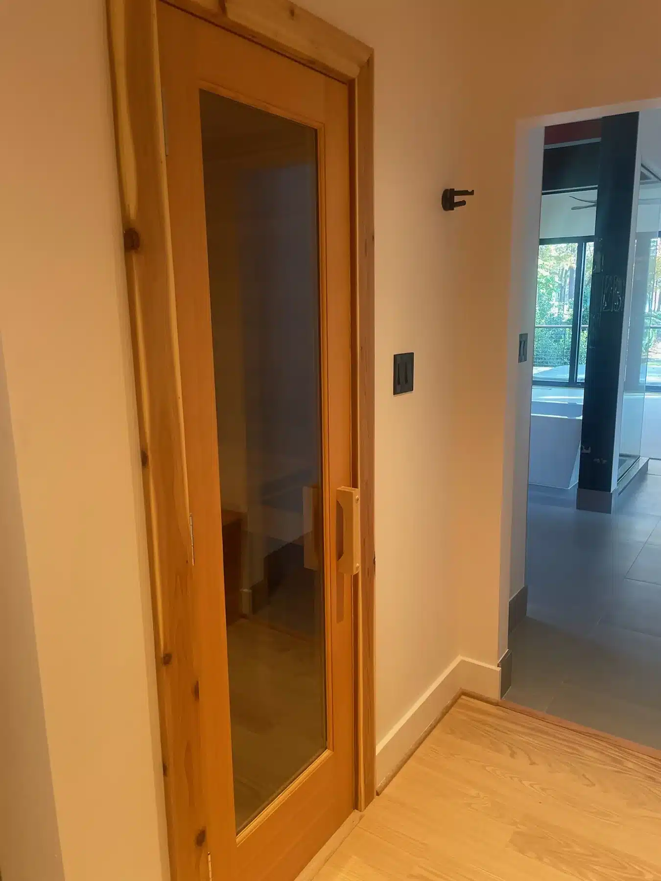 Finished wood and glass entrance to the small Richmond custom sauna