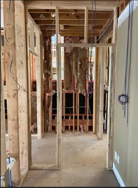 Wall framing for the compact sauna beside a Richmond primary bathroom