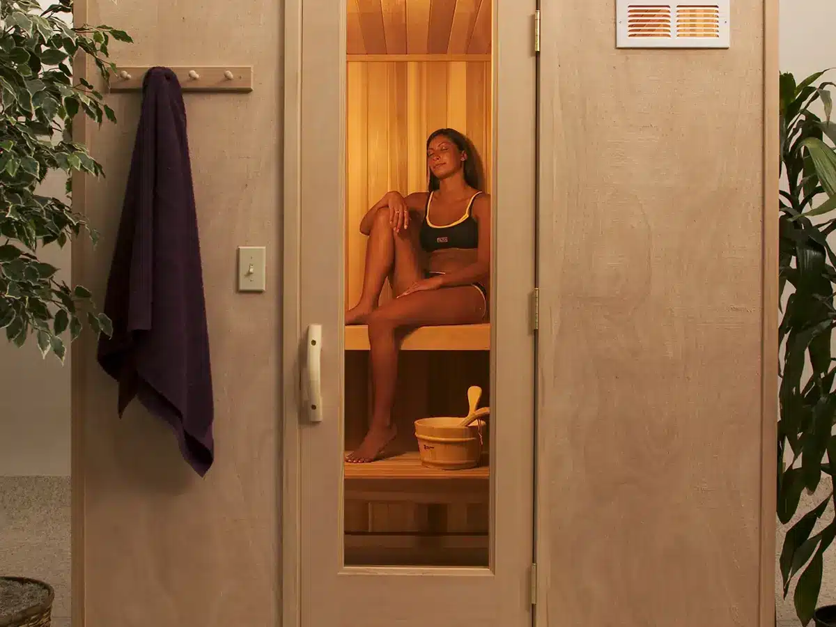 Freestanding Finlandia FPF prefabricated sauna room with a glass door