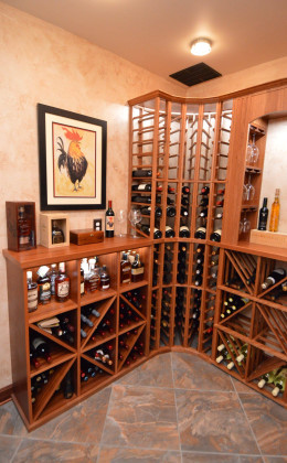 Camberra Mahogany racking from Genuwine Cellars combine with custom shelving to house both wines and whiskey in this home cellar.