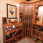 Camberra Mahogany racking from Genuwine Cellars combine with custom shelving to house both wines and whiskey in this home cellar.
