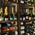 Subtle and effective lighting is worked into every section of the Rosewood Hotel wine cellar.