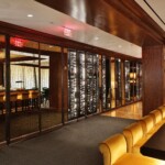 Mirrors are a beautiful addition to this stunning Rosewood Hotel wine wall.