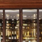 The grille at the top of the cabinet hide a critical component in custom wine cellar design - the cooling unit.