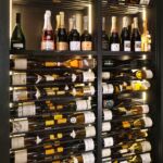 Metal rods paired with the mahogany shelving and enclosure look wonderful together in the Rosewood Hotel wine cellar.