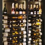 Metal rods paired with the mahogany shelving and enclosure look wonderful together in the Rosewood Hotel wine cellar.