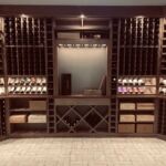The display nook located in the center of the custom wine cellar serves as a visual focal point for this stunning wine storage room.