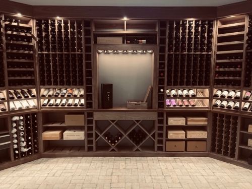 The display nook located in the center of the custom wine cellar serves as a visual focal point for this stunning wine storage room.