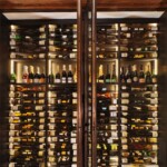 Metal trim on the glass doors adds an elegant touch to the custom wine cellar in the Rosewood Hotel.