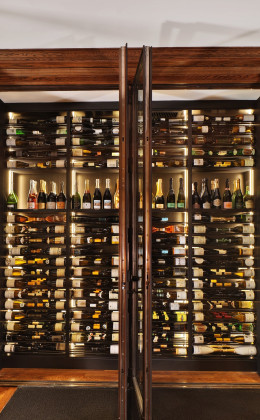 Metal trim on the glass doors adds an elegant touch to the custom wine cellar in the Rosewood Hotel.