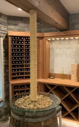 Corner wine racking and tasting nook in a custom home wine cellar.