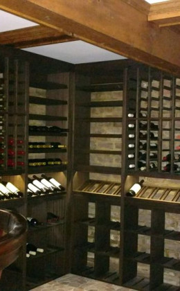 Wooden wine racking with a dark stain looks great in this traditional basement wine cellar.