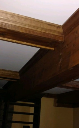 This traditional wine cellar was designed to incorporate the existing structure in the basement.