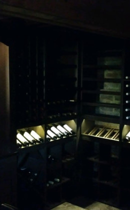 The lighting elements in the display row highlight the beautiful wine bottles.