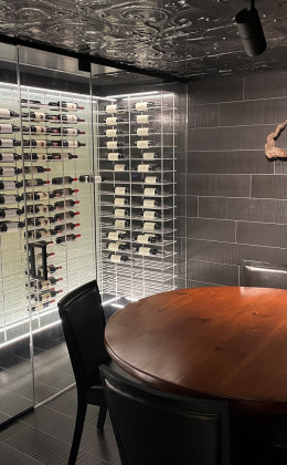 This contemporary wine cellar features a design that ties in perfectly with the very stylishly designed room.