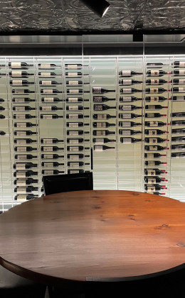 These Maryland homeowners can enjoy a glass of wine with friends and family at the tasting table with enjoying the beautiful views of the modern cellar.