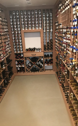 This beautiful wine cellar features multiple formats of bottle storage, including cork-forward wooden racking and spacious "X-bins".