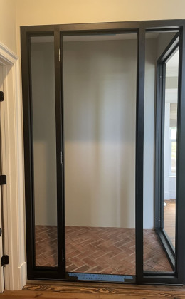 Framed glass walls give custom home wine cellars a more modern look and feel.