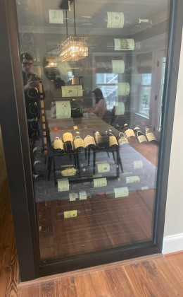 Glass wine cellar walls make it easy to see the contents.