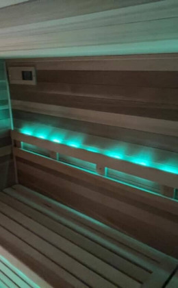 Traditional custom home sauna in Outer Banks, Corolla City with modern heating and temperature control devices. Corolla City Custom Home Sauna Outer Banks Traditional Design