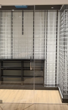 Glass walls and doors with acrylic racking make this home wine cellar look very modern.