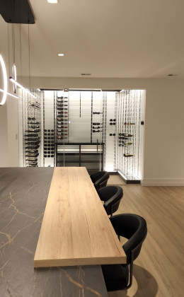 This homeowner wanted a modern glass wine cellar in his home bar area.