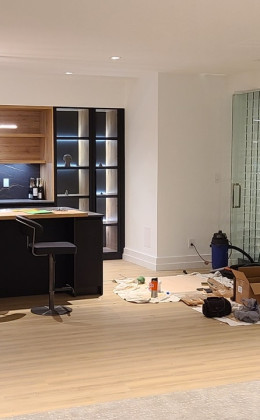 Construction is underway on this modern glass home wine cellar.