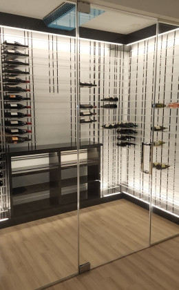 Custom lighting is a beautiful and important component in glass wine cellars.
