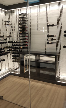 With acrylic racking, the bottles seems to float in mid-air in this modern glass home wine cellar.